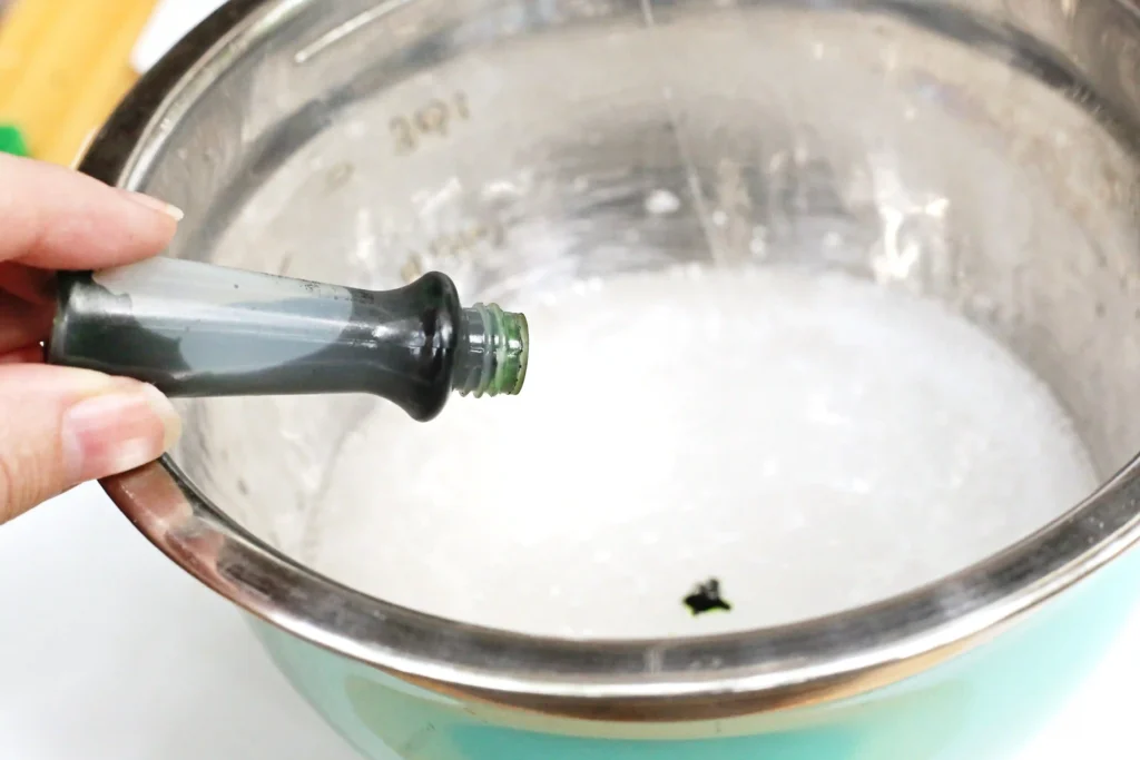 green food coloring being added to the slime