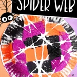 a Spider Web Painting on a paper plate with sponges and orange and purple paper in the background