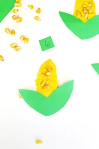 a fall counting activity for preschoolers that has corn kernels in playdough that looks like corn