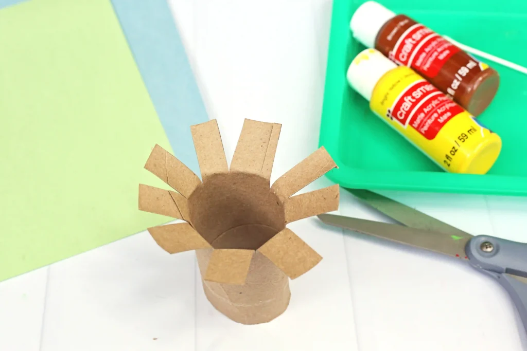 a toilet paper roll with the ends cut for this recycled craft