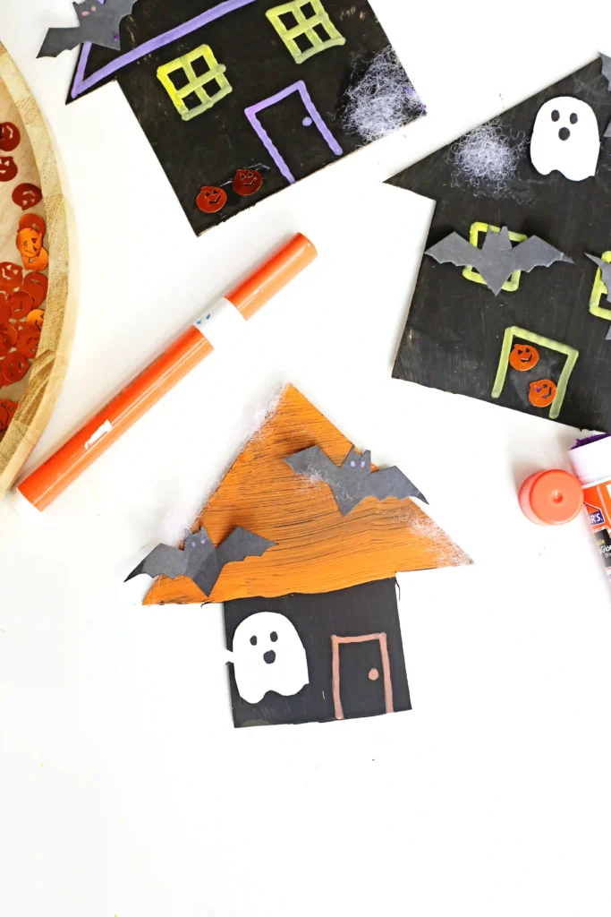 cardboard painted and decorated to look like haunted houses