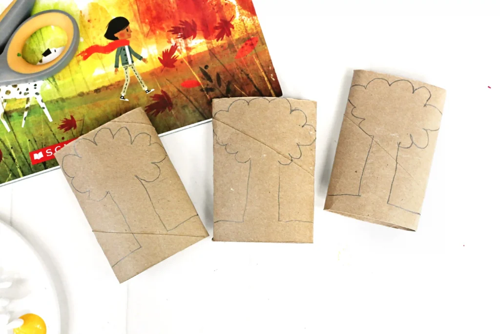 flattened toilet paper rolls with trees drawn on them