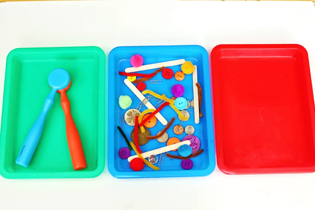 supplies for the magnetic sorting STEM activity - trays, magnet, and various magnetic and non-magnetic items
