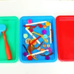 supplies for the magnetic sorting STEM activity - trays, magnet, and various magnetic and non-magnetic items