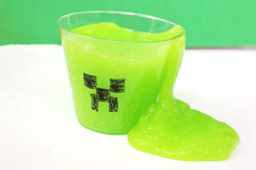 Minecraft Creeper Slime - green slime in a cup with a minecraft face draw on