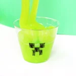 Minecraft Creeper Slime - green slime in a cup with a minecraft face draw on