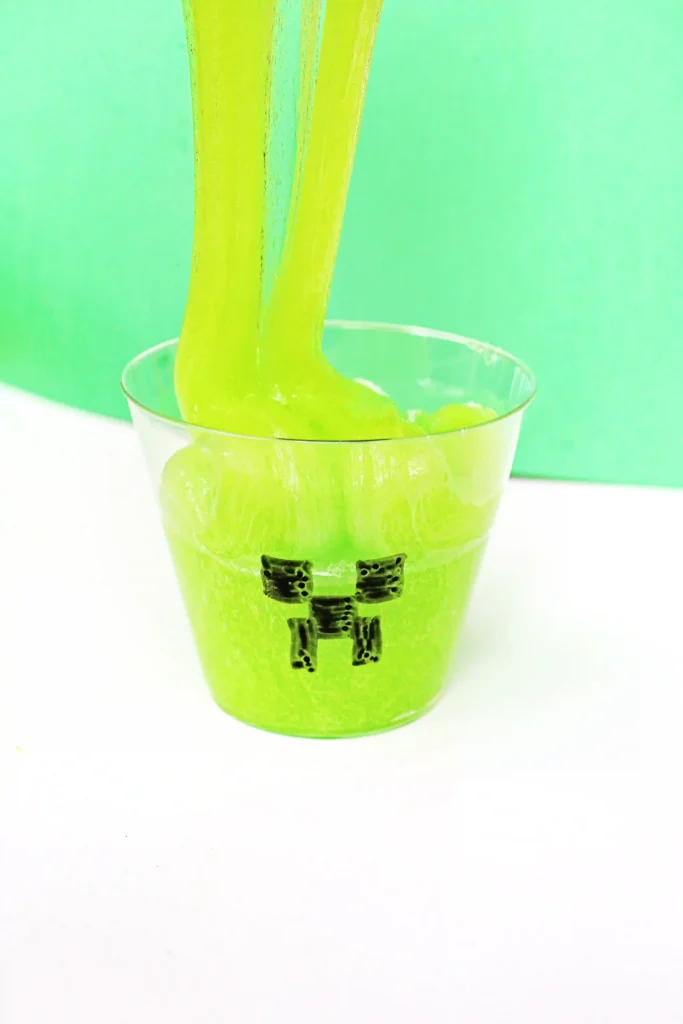 Minecraft Creeper Slime - green slime in. a cup with a minecraft face draw on