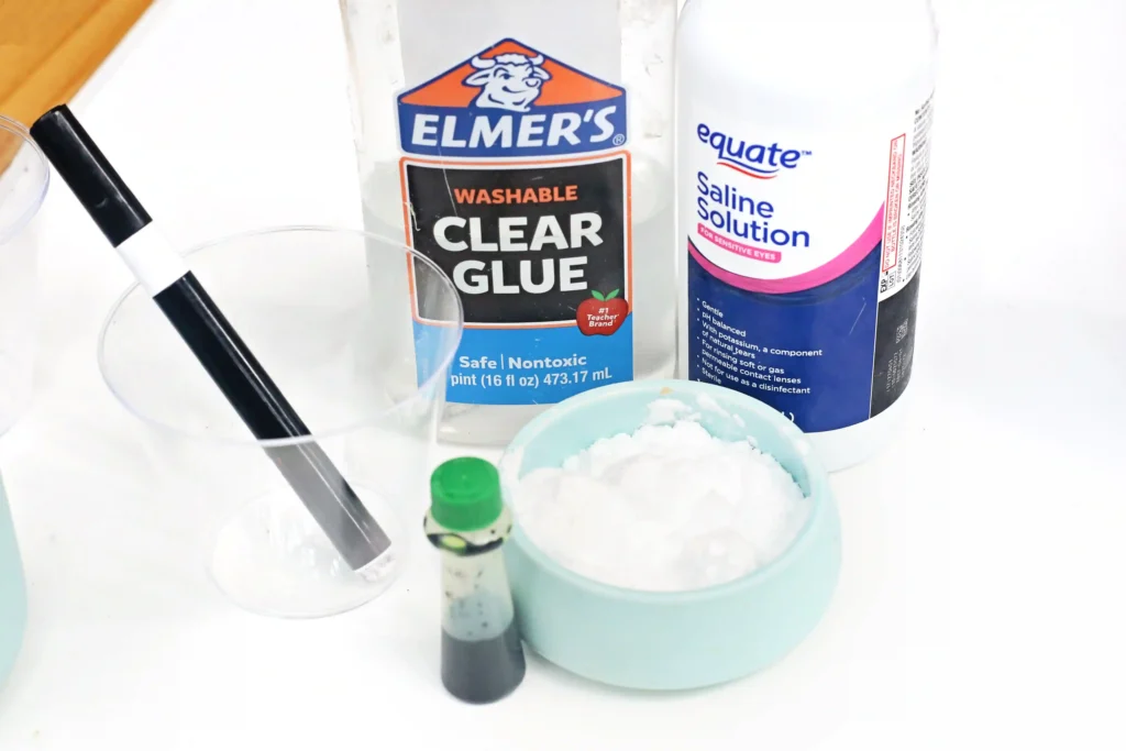 ingredients for the slime recipes: glue, saline solution, food coloring, and a black marker