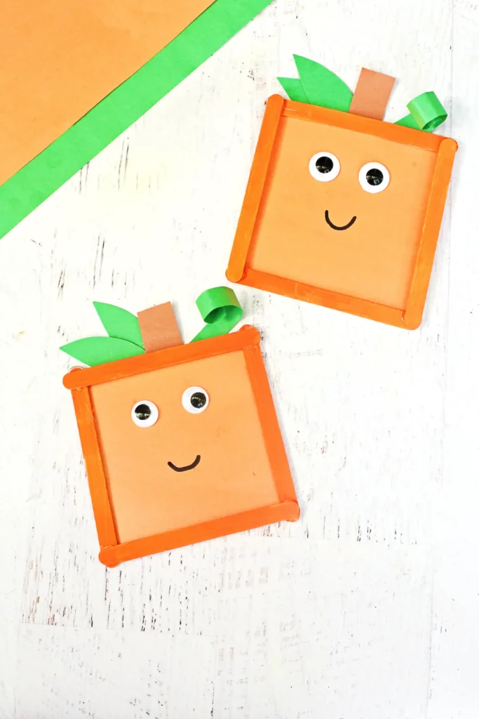 Spookley the square pumpkin crafts that uses orange popsicle sticks, green and orange construction paper, and googly eyes to make a square pumpkin