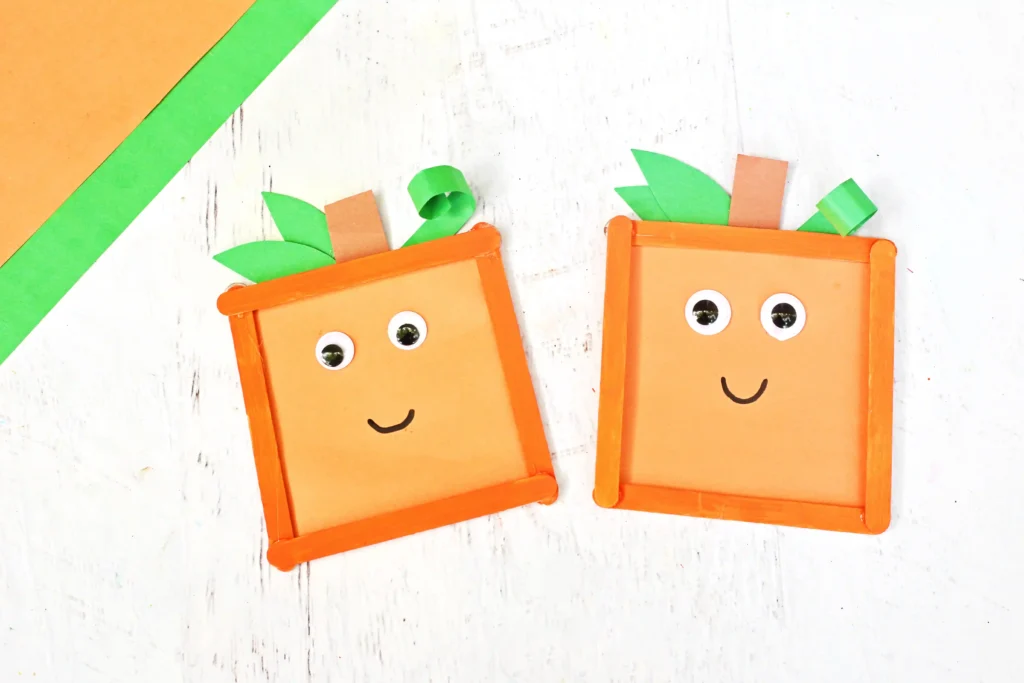 Spookley the Square Pumpkin Popsicle Stick Craft that uses orange popsicle sticks, green  and orange construction paper, and googly eyes to make a square pumpkin
