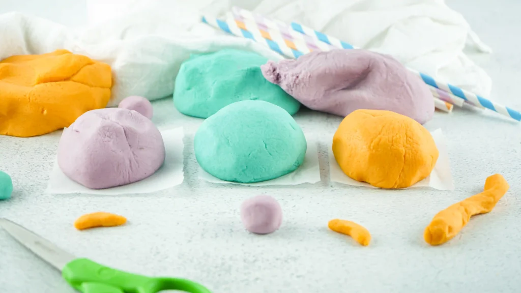 homemade playdough recipe that makes blue, purple, and orange playdough for kids