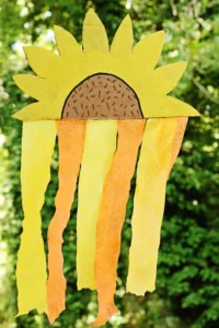 a Cardboard Sunflower Streamer made out of painted cardboard and orange and yellow streamers