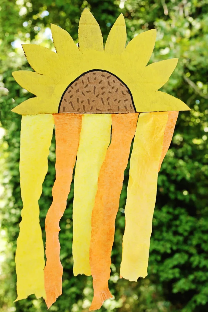 a Cardboard Sunflower Streamer made out of painted cardboard and orange and yellow streamers