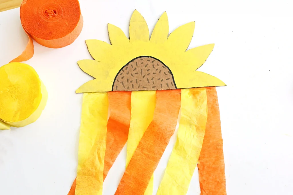 a Cardboard Sunflower Streamer made out of painted cardboard and orange and yellow streamers