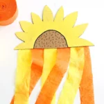 a Cardboard Sunflower Streamer made out of painted cardboard and orange and yellow streamers