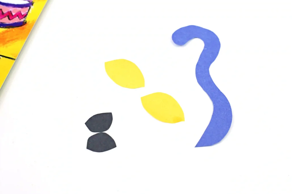 eyes and a tail cut out of colored construction paper
