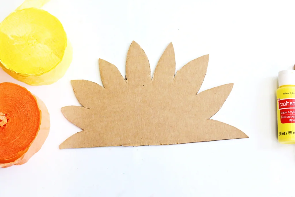 a half-sunflower shape cut out of cardboard