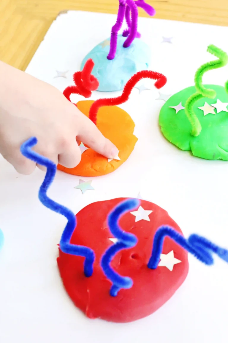 a Fireworks Playdough Tray that uses playdough, pipe cleaners, and foam stars to look like fireworks