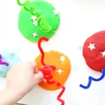 a Fireworks Playdough Tray that uses playdough, pipe cleaners, and foam stars to look like fireworks