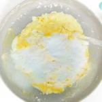 a kid using a dropper to drop vinegar on a baking soda moon
