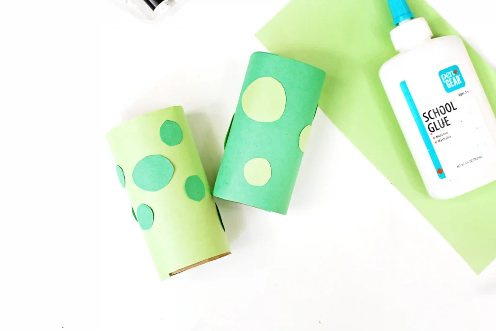 toilet paper rolls wrapped in green paper with green spots