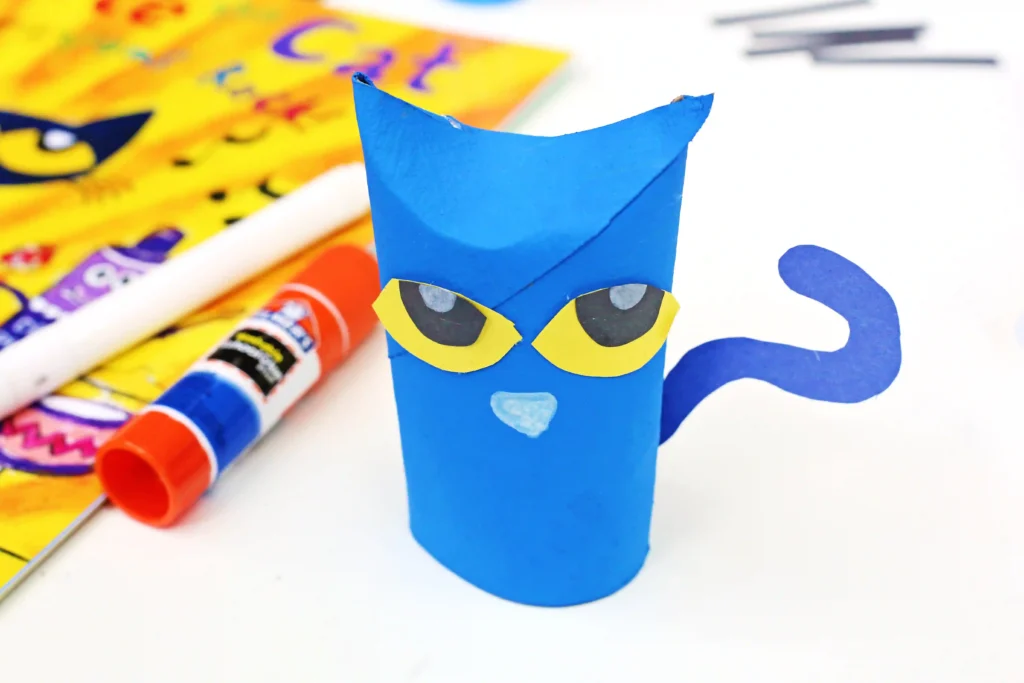 a toilet paper roll painted blue and decorated to look like pete the cat