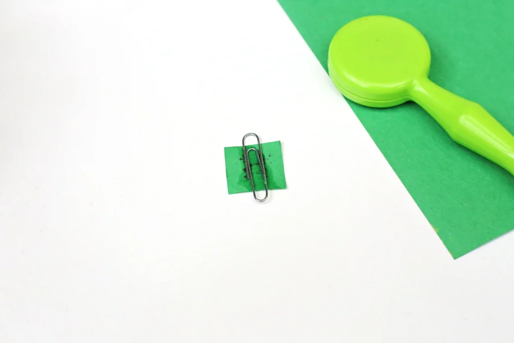 a paper clip glued to the back of a small piece of green construction paper