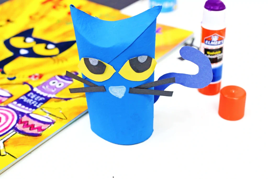 a toilet paper roll painted and decorated to look like pete the cat