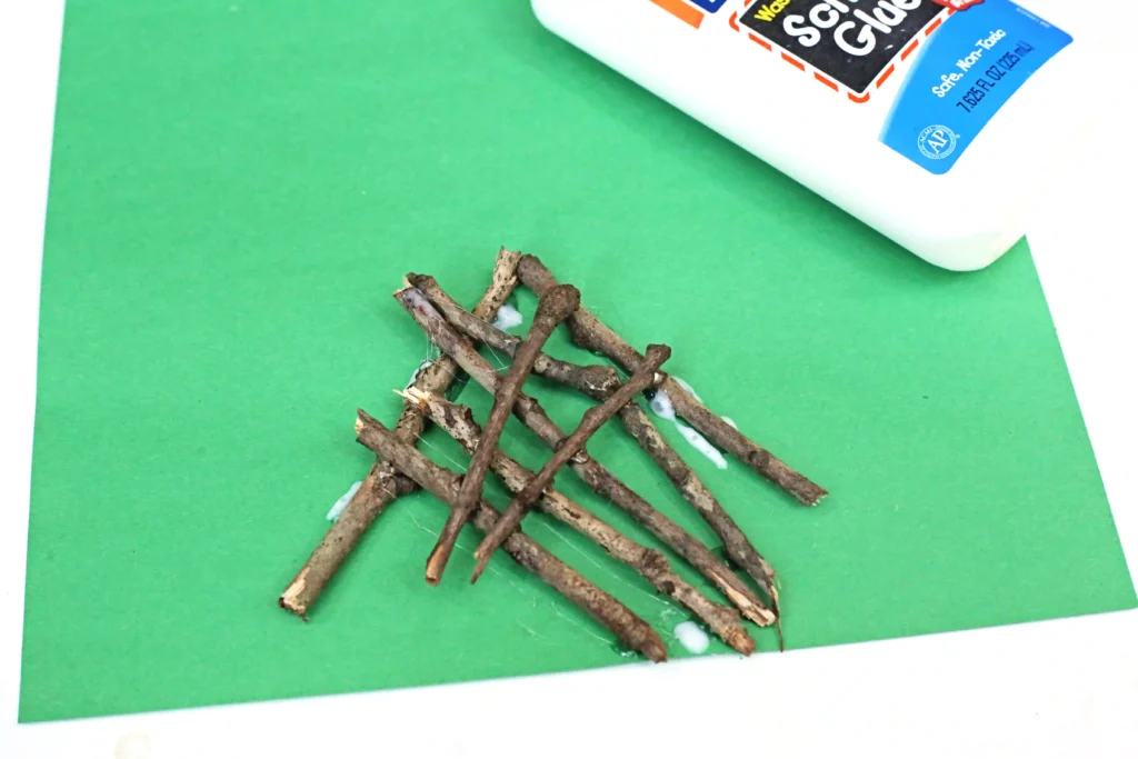 sticks glued onto green construction paper to look like the base of a fire