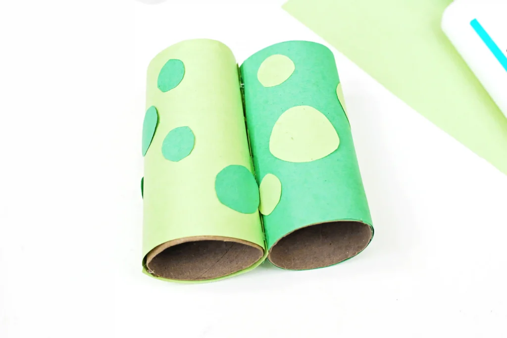 toilet paper rolls wrapped in green paper with green spots and glued together