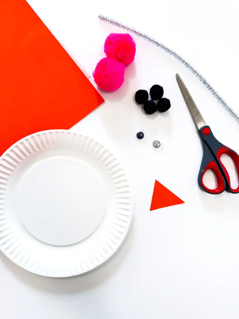 a paper plate next to craft supplies