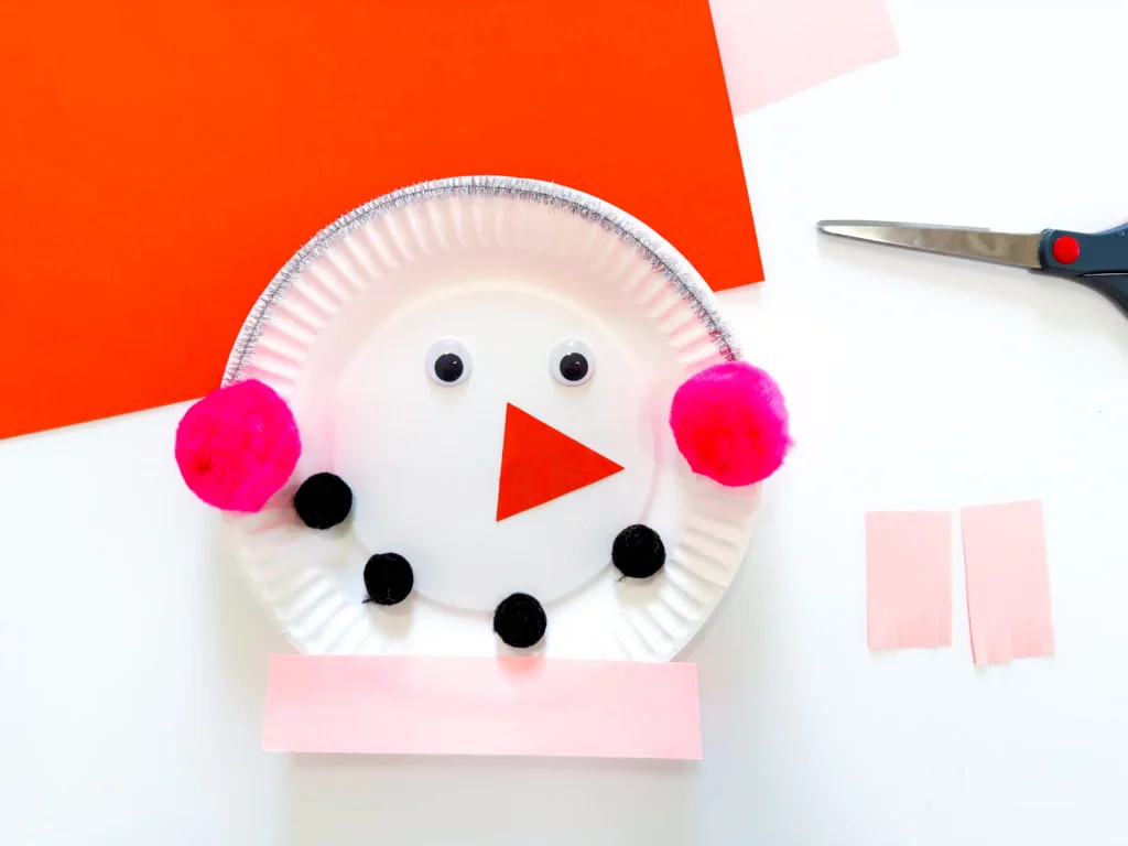 paper plate decorated to look like snowmen