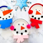 paper plates decorated to look like snowmen