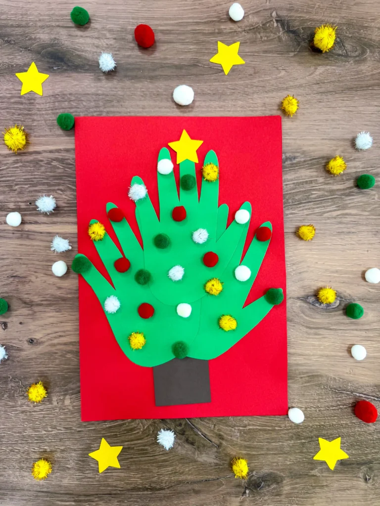 a christmas card of 3 handprints that make a christmas tree with pom poms glued on