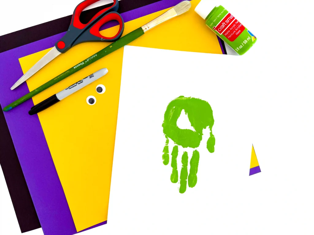 a piece of paper with a green handprint