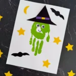 a Handprint Witch Craft of a green handprint decorated to look like a witch