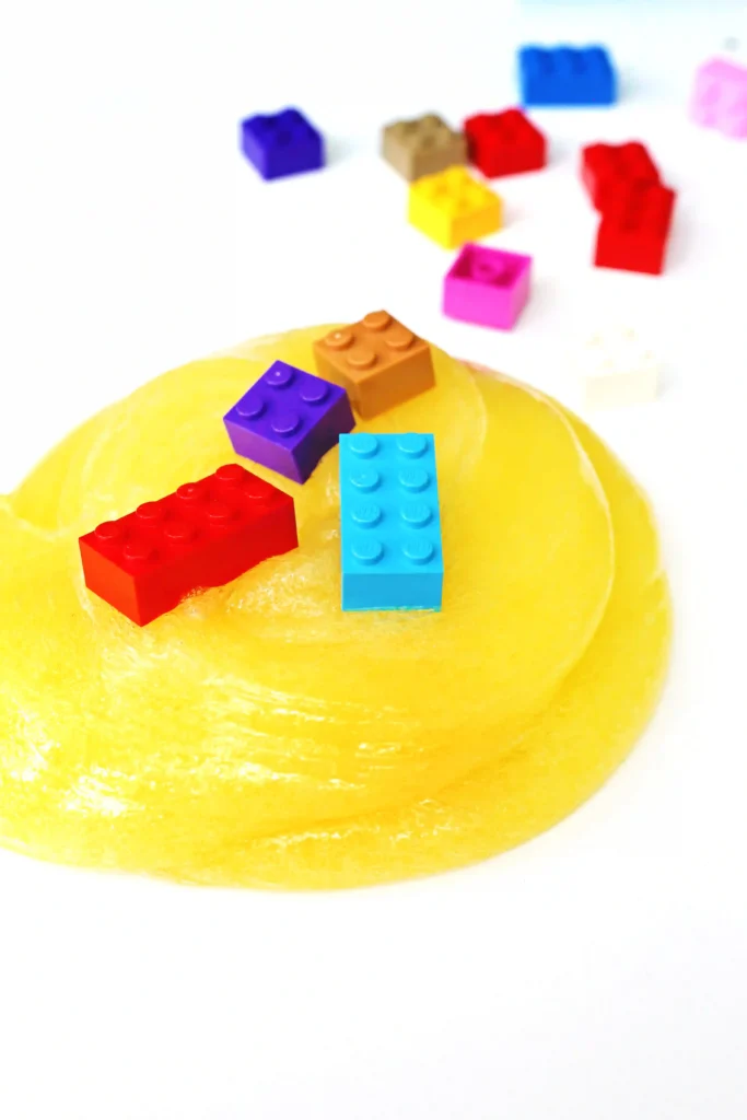 LEGO slime that is yellow slime with colorful legos mixed in