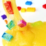 LEGO slime that is yellow slime with colorful legos mixed in