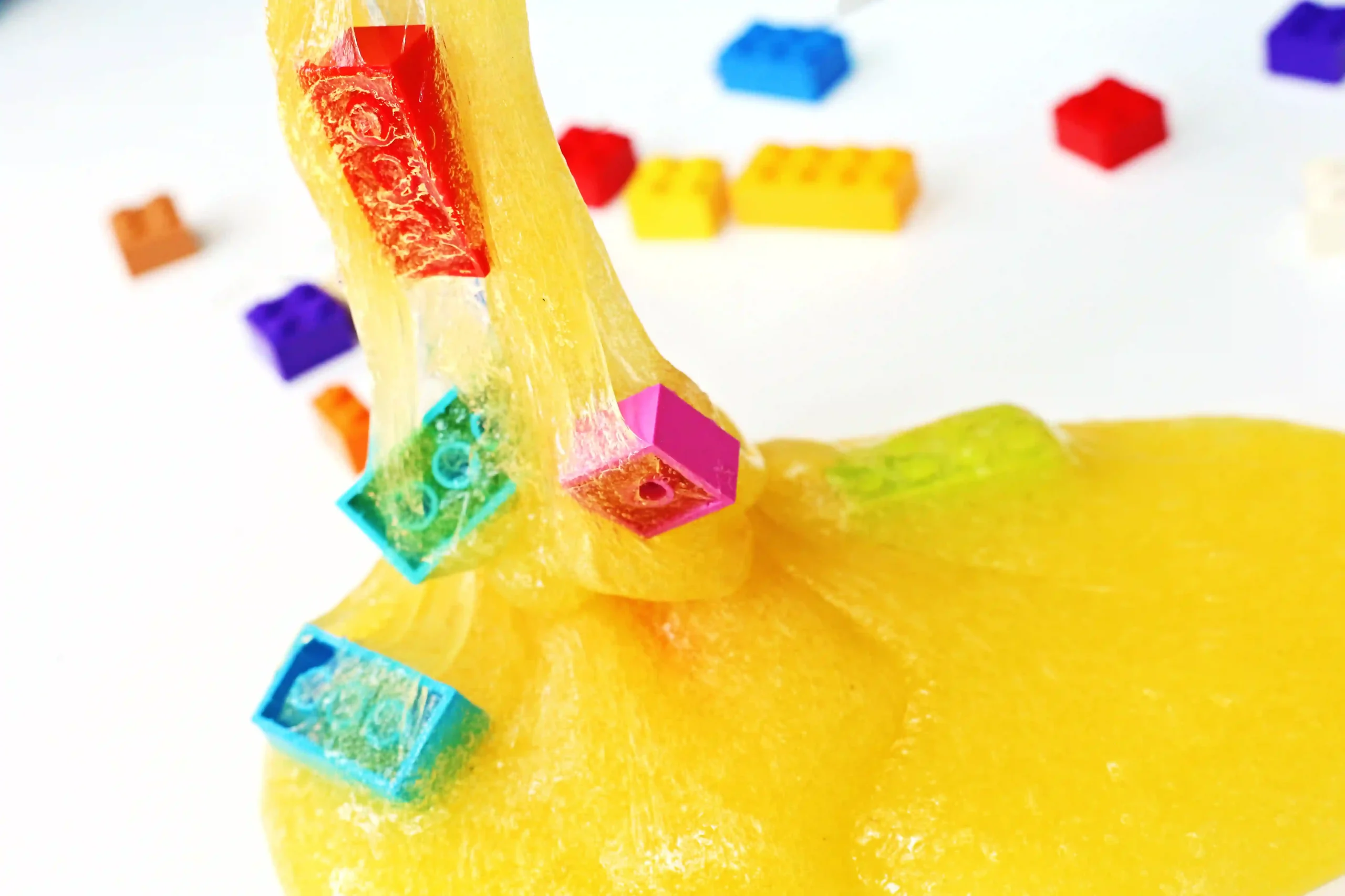 LEGO slime that is yellow slime with colorful legos mixed in