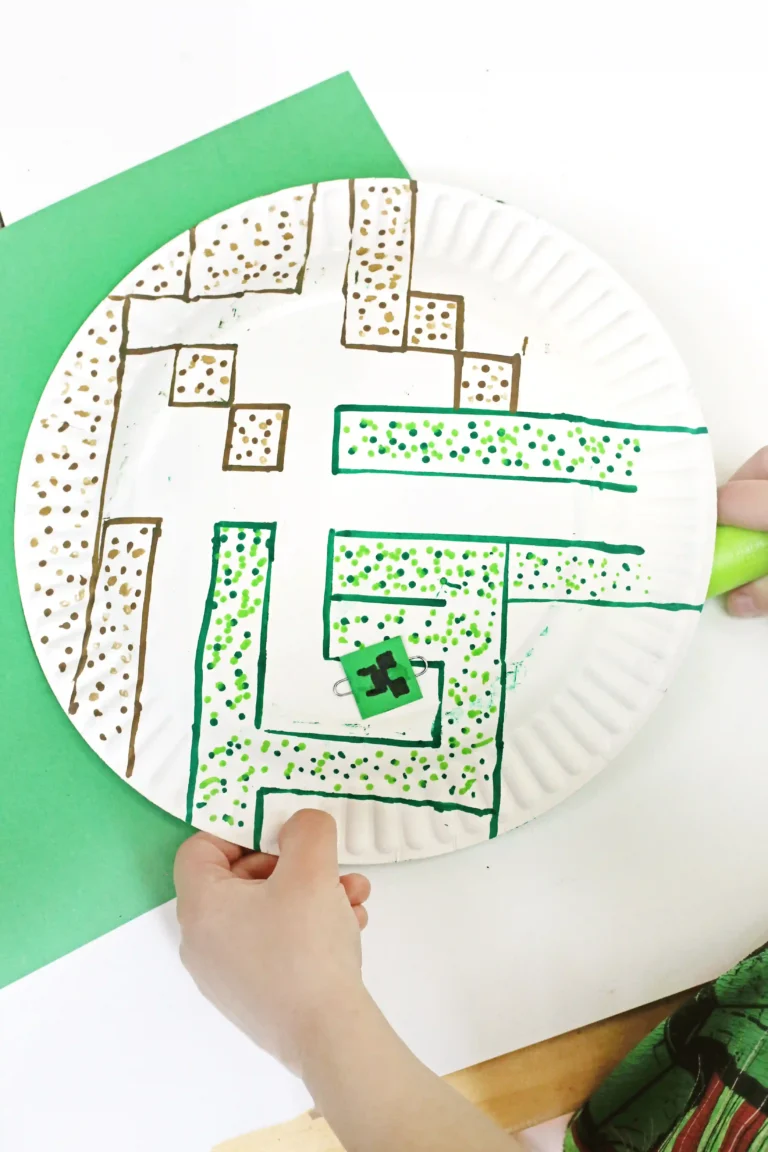 a paper plate with a maze drawn on it next to a magnet