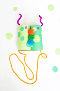 Monster Binoculars made out of toilet paper rolls, pom poms, construction paper, and pipe cleaners