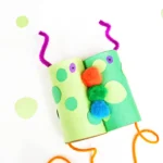Monster Binoculars made out of toilet paper rolls, pom poms, construction paper, and pipe cleaners