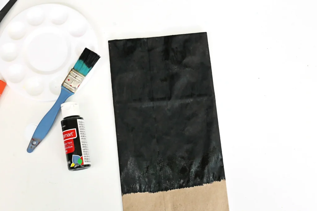 a paper lunch bag painted black