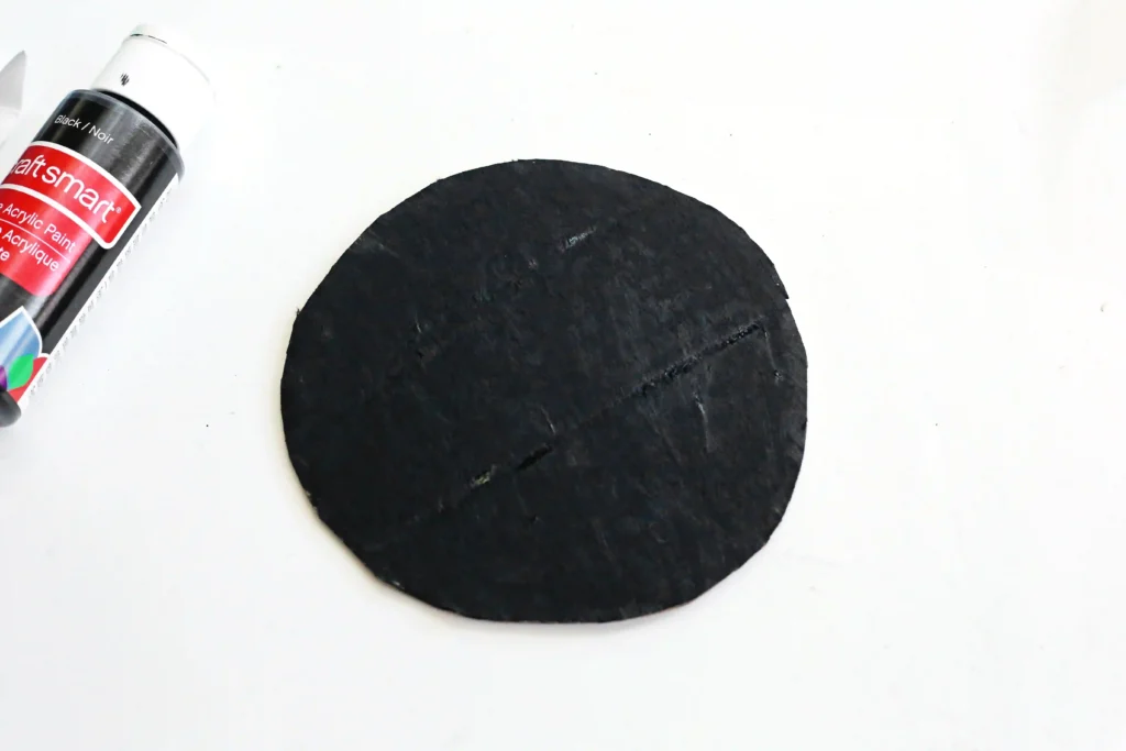 a cardboard circle painted black