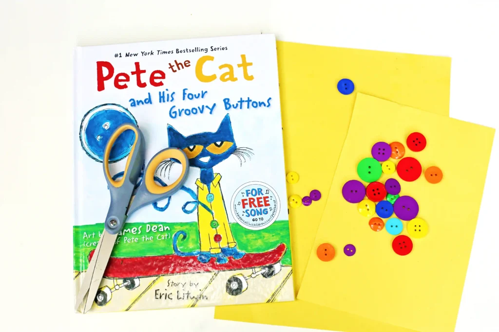 supplies for the pete the cat counting activity: yellow construction paper, buttons, scissors, and a pete the cat book