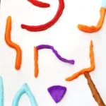 a pinball game made out of playdough with a marble