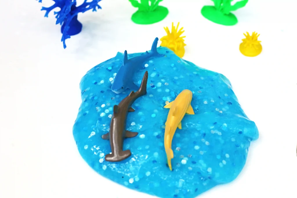 shark slime: blue slime with glitter and toy sharks