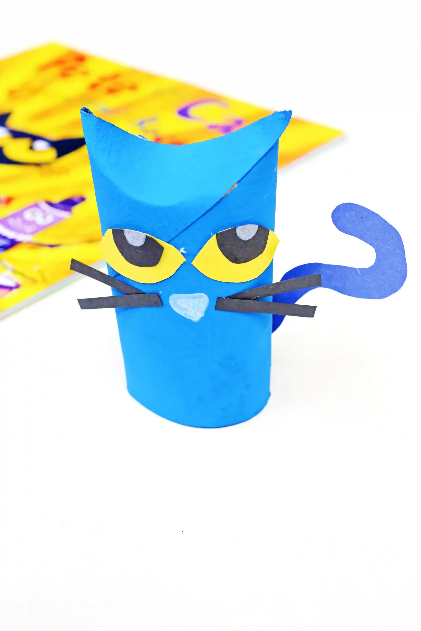 a toilet paper roll painted and decorated to look like pete the cat