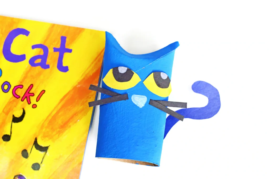 a toilet paper roll painted and decorated to look like pete the cat