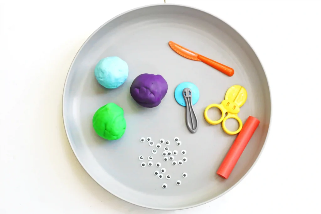 supplies for this toy story alien playdough tray - playdough, googly eyes, and playdough tools
